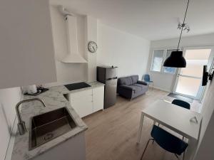 a kitchen and living room with a sink and a table at Il Riposino in Forlì