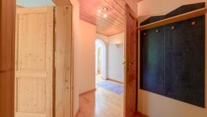 a hallway with an open door and a blackboard at Haus Röthelsteinblick in Bad Aussee