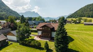 an aerial view of a house with mountains in the background at Haus Röthelsteinblick in Bad Aussee