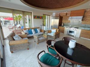 a large living room with a table and chairs at Luxury Cabo Villa Stunning Ocean Views in Cabo San Lucas