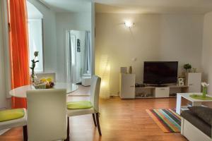 a living room with a table and a television at West Wall Apartment in Split