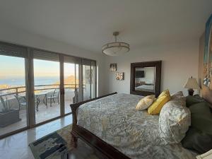 a bedroom with a bed and a view of the ocean at Luxury Cabo Villa Stunning Ocean Views in Cabo San Lucas +80 photos