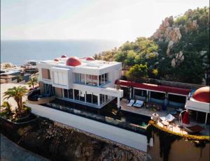 a white building with a red dome on top of it at Luxury Cabo Villa Stunning Ocean Views in Cabo San Lucas