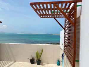 a bathroom with a view of the ocean at Casa Tud Dret - By Bobbywashere in Sal Rei