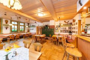 a restaurant with wooden floors and tables and chairs at Hotel Stadt Suhl in Zella-Mehlis