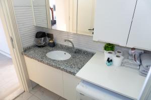 a bathroom counter with a sink and a mirror at Galfa House in Bostancı +13 photos