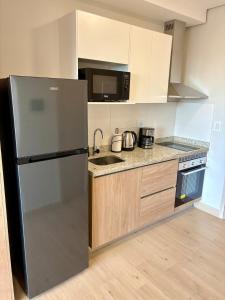 a kitchen with a refrigerator and a sink at Matrisa Boggiani 805 - Vivelite in Asuncion
