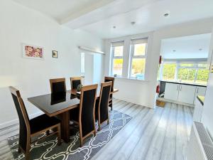 a dining room with a table and chairs at Spacious Haven with Free Parking in Glasgow +43 photos