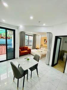 a living room with a bed and a table and chairs at 25 House 298 Ngoc Lam - Long Bien bridge in Hanoi