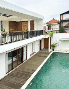 a house with a swimming pool in front of a building at Casa De Cuentos Bali in Denpasar +4 photos
