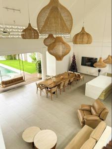 a living room with a long table and chairs at Casa De Cuentos Bali in Denpasar