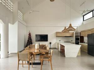 a kitchen with a table and chairs and a christmas tree at Casa De Cuentos Bali in Denpasar