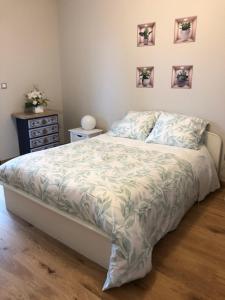 a bedroom with a bed and pictures on the wall at Le Colbert in Nevers