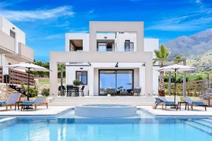 a villa with a swimming pool in front of a house at Minaos in Kournás