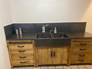 a kitchen counter with a sink and wooden cabinets at Joyeux Flocon - Spacieux chalet in Les Contamines-Montjoie +23 photos