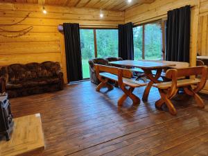 a living room with a table and chairs and a couch at Piglet house in Alytus