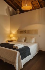 a bedroom with a large bed with a black and white blanket at 120 Hotel & Beach Club in Guarujá +47 photos