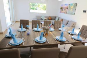 a long wooden table with plates and dishes on it at Villa Llevant in Miami Platja