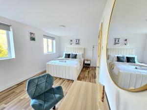 a bedroom with two beds and a mirror at Spacious Haven with Free Parking in Glasgow