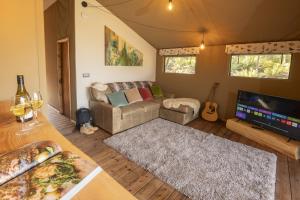 a living room with a couch and a flat screen tv at Windermere - Safari Suite in Ambleside