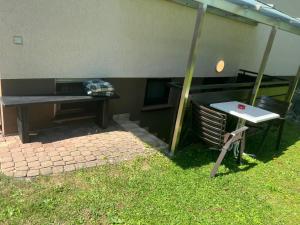a picnic table and a bench next to a building at LUNA in Bad Säckingen