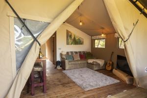 a living room with a couch in a tent at Windermere - Safari Suite in Ambleside