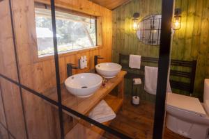 a bathroom with two sinks and a toilet at Windermere - Safari Suite in Ambleside +35 photos