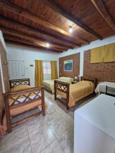 a large room with two beds and a table at Cabañas El Sauce in Albardón +36 photos