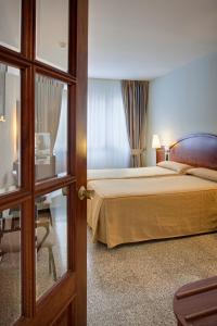 Postel nebo postele na pokoji v ubytování Hotel Gaudi
