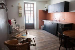a kitchen with a table and chairs and a table at Appartement rénové sur le thème du Far West in Soyaux