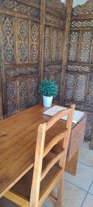 a wooden table with a potted plant on top of it at Bloom in Bloemfontein