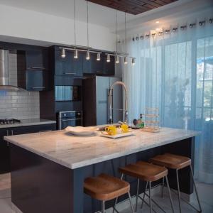 a kitchen with a counter with bananas on it at Red Heart 3 Bedrooms Villa in Sosua