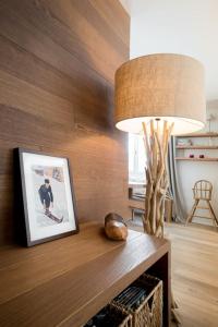 a table with a picture and a lamp on it at Alpine Chic Apartment in Andermatt
