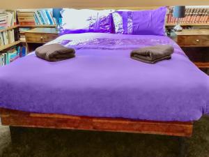 a purple bed with two pillows on it at Heddfan - Uk47835 in Llanboidy
