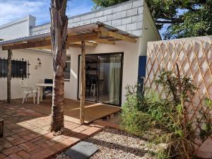 una casa con terrazza in legno e tavolo di The Seabird Cottage a Gqeberha Altre 4 foto