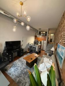 a living room with a couch and a table at Downtown Charleston Condo in Charleston
