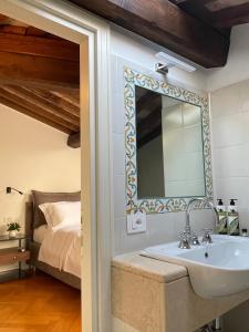 a bathroom with a sink and a bed at Residenza Zaccone in Tivoli +35 photos