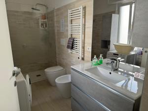 a bathroom with a sink and a toilet at B&B Il sogno in Cagliari