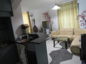 a living room with a couch and a table in a room at Hostel Papagal in Varna City