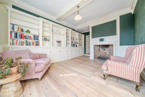 a living room with a couch and a fireplace at 6 Angel Hill, Bury st Edmunds in Bury Saint Edmunds
