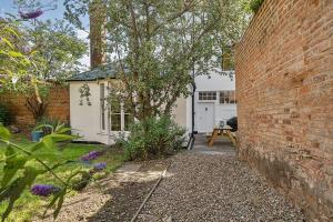 a brick wall in front of a white garage at 6 Angel Hill, Bury st Edmunds in Bury Saint Edmunds