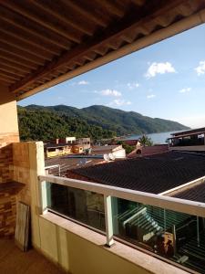 a balcony with a view of the water and mountains at Recanto da Jane e Daniel in Angra dos Reis