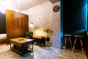 a living room with a couch and a table and stool at The Industry in Galaţi