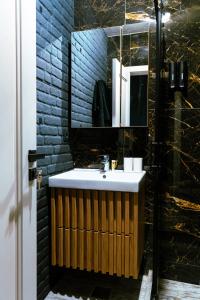 ein Badezimmer mit Waschbecken und Spiegel in der Unterkunft The Industry in Galaţi + 6 Fotos