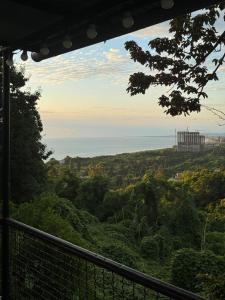 a view of the ocean from a hill with trees at Tsikhisdziri Home in Tsikhisdziri