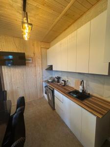 a kitchen with white cabinets and a counter top at Tsikhisdziri Home in Tsikhisdziri