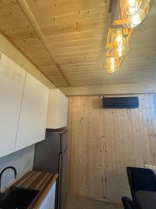 a kitchen with white cabinets and a chandelier at Tsikhisdziri Home in Tsikhisdziri +8 photos