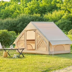 a tent in a field with a table at Bertinus Medieval Lodge Camping in Serra Negra
