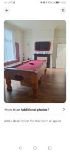 a room with a pool table in the middle at Beaconsfield Square in Hartlepool