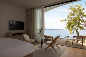 a bedroom with a bed and a view of the ocean at Silversands Beach House Grenada in Bamboo